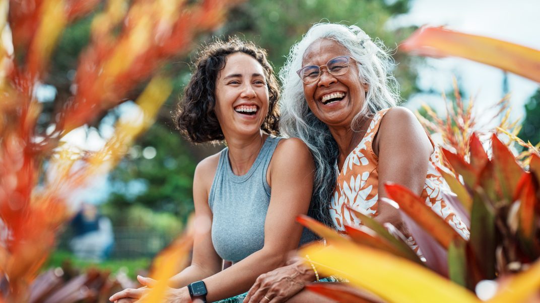 Elderly woman and daughter laughing