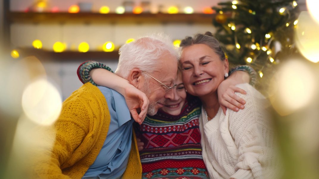 Gifts for seniors - Family hugging and smiling