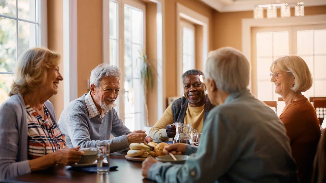 A group of seniors sitting at a table and developing social connections