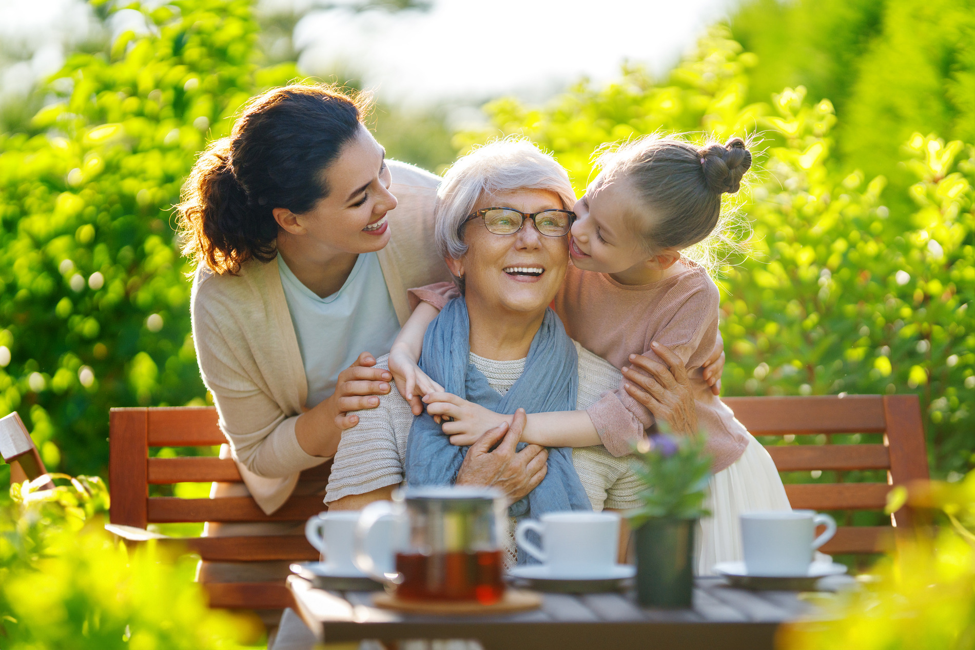 Senior woman smiling with her daughter and granddaughter.