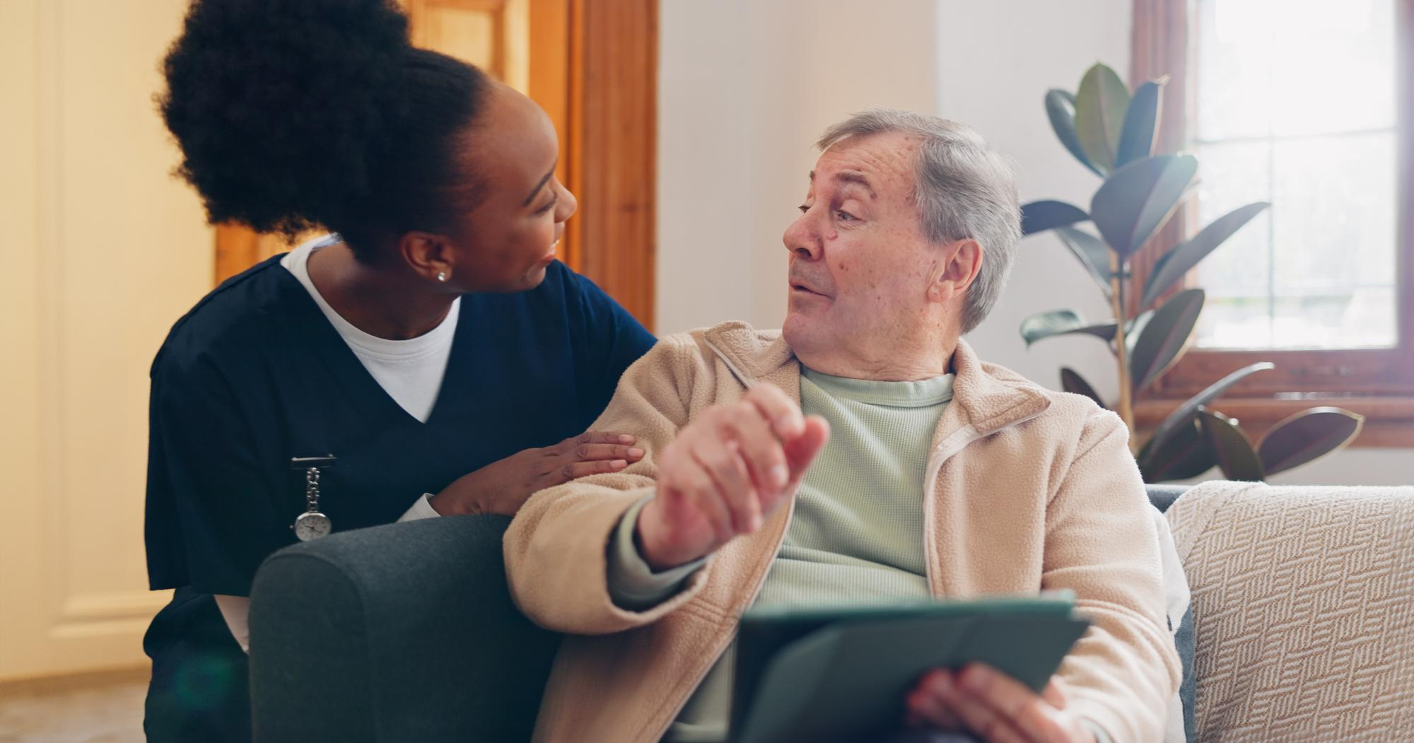 Caregiver and senior having a conversation about in-home care.