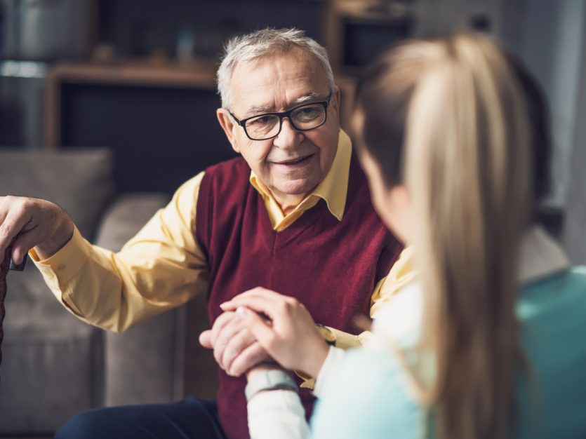 Caregiver holding a senior's hand