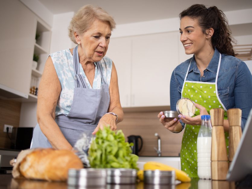 Volunteer is helping an elderly woman