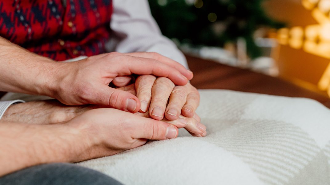 Holding the hands of an older adult - Discussing Home Care With Aging Parents