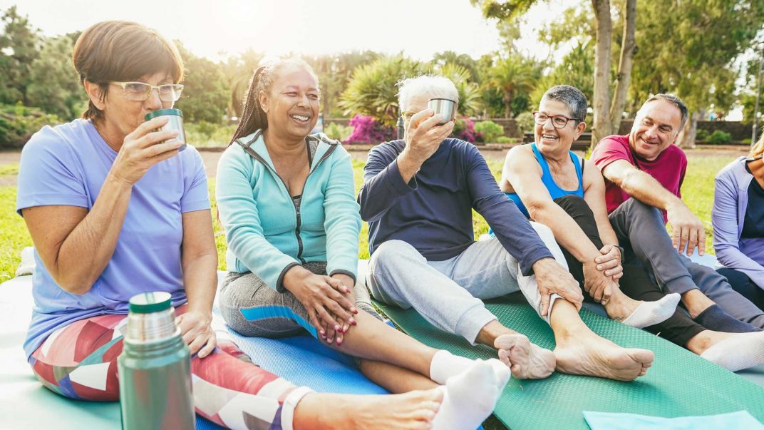World Cancer Day 2025: "United by Unique" 1 a group of people sitting on yoga mats