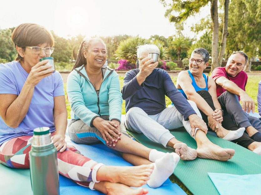 World Cancer Day 2025: "United by Unique" 1 a group of people sitting on yoga mats