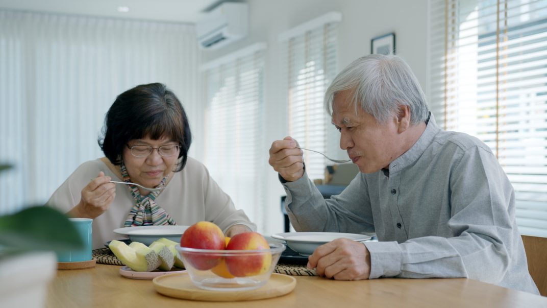 Living with prediabetes or type 2 diabetes? 3 areas to consider! 1 Older adult couple sitting at their dining room table and eating soup.
