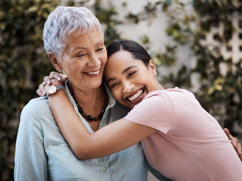 Daughter hugging senior mother