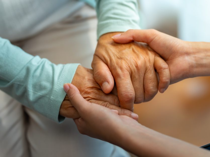 Supporting a Loved One Living with Alzheimer’s 2 Alzheimer's care - Two hands holding each other gently.