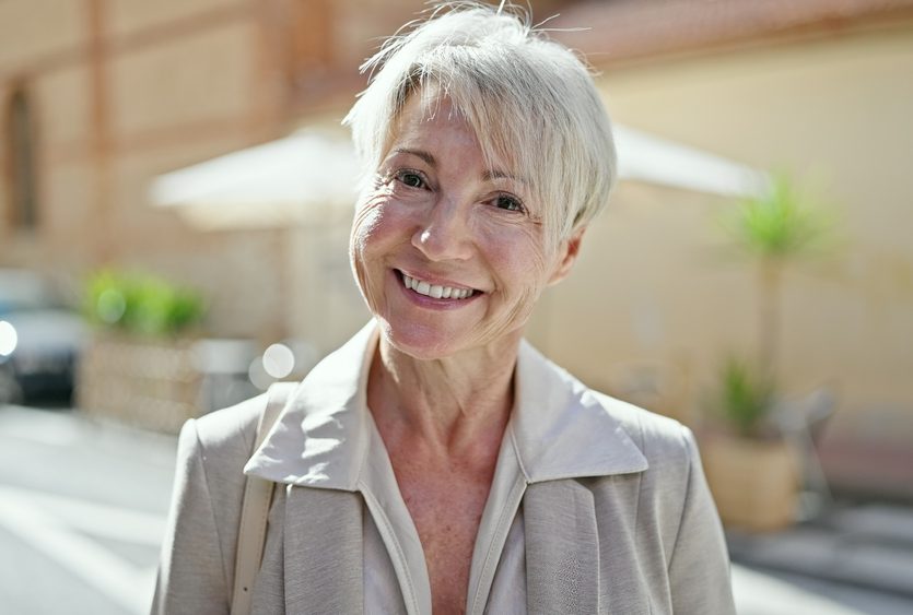 Happy senior woman smiling while being outdoors