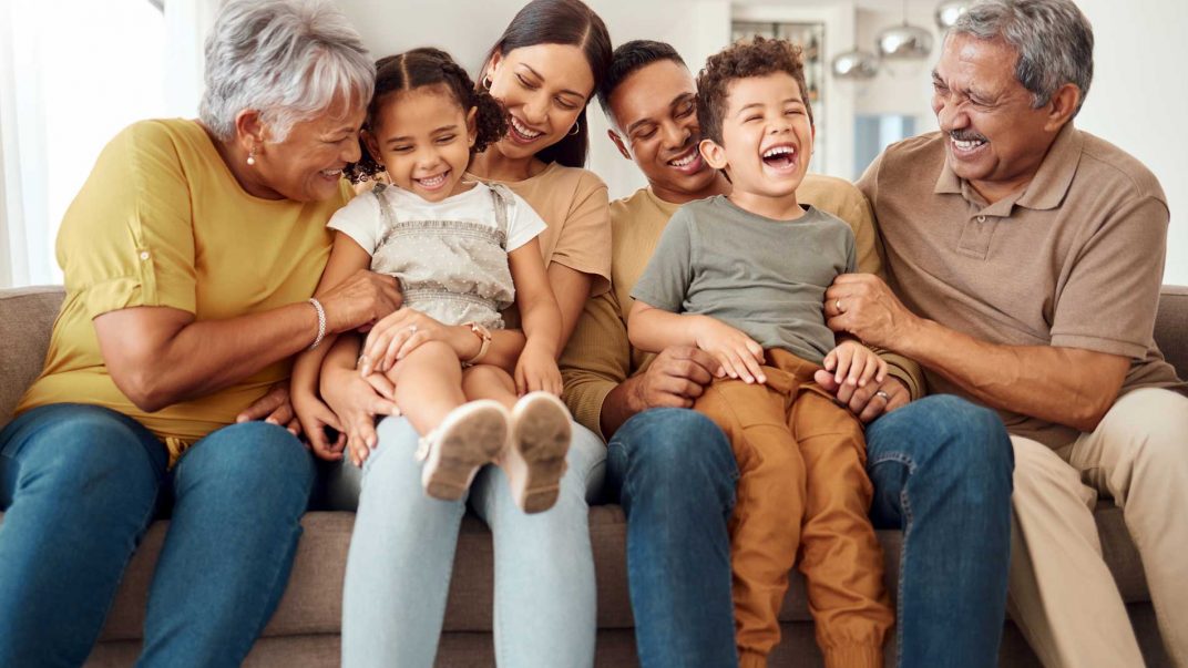 Transitions in Later Life – Part 1: Navigating grandparenthood 1 Family sitting together on couch.