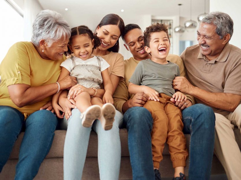 Family sitting together on couch.