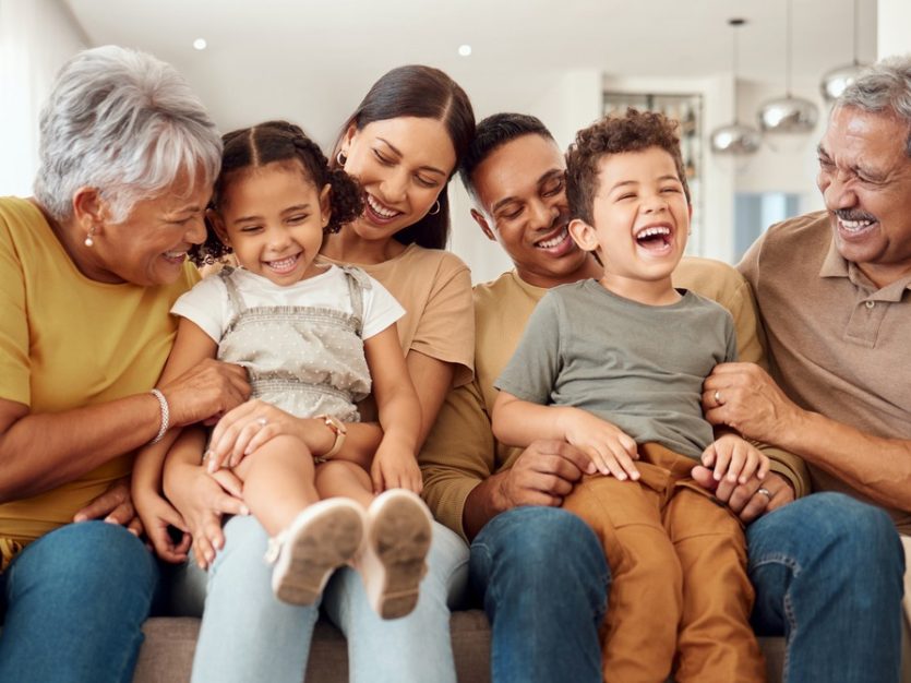 Extended family laughing on couch