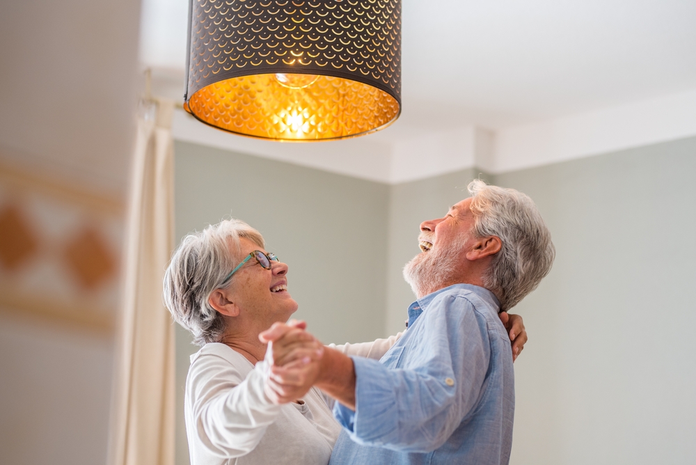 Elderly couple dancing indoors together -Moments of Love: Celebrating the Connections That Help Us Age Well
