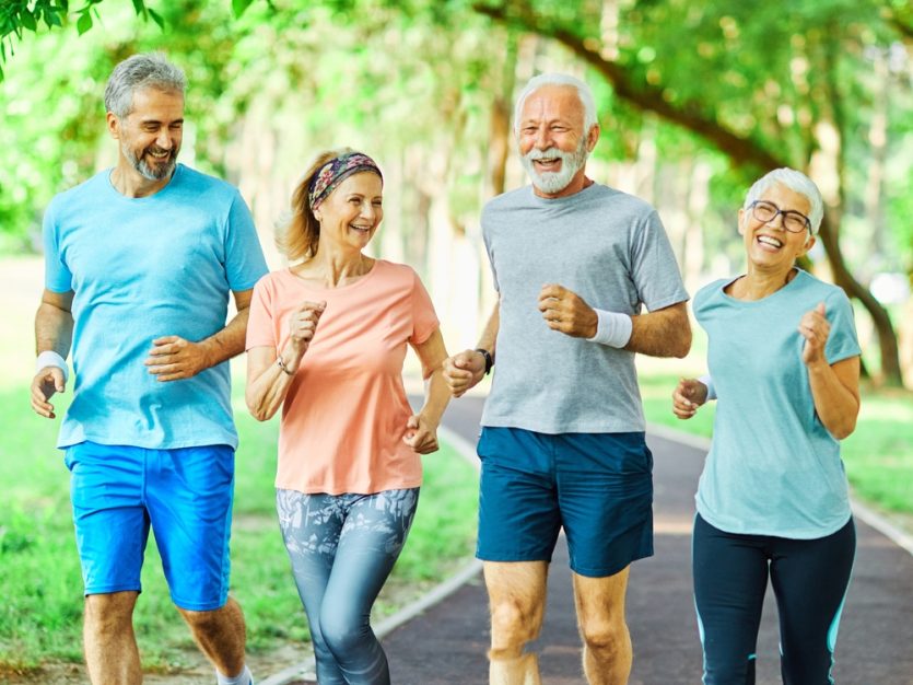 Group of seniors jogging outdoors.