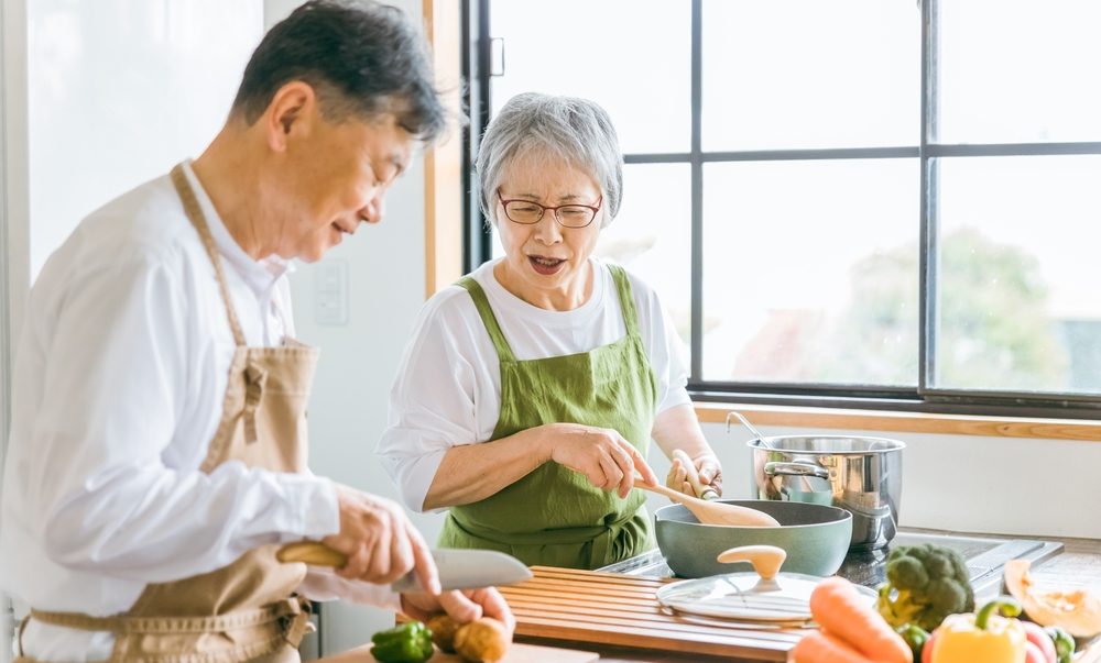 Asian elderly cooking in the kitchen - Supporting heart health