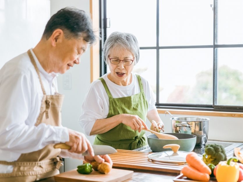 Asian elderly cooking in the kitchen - Supporting heart health