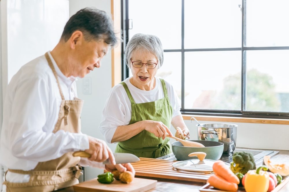 Asian elderly cooking in the kitchen - Supporting heart health