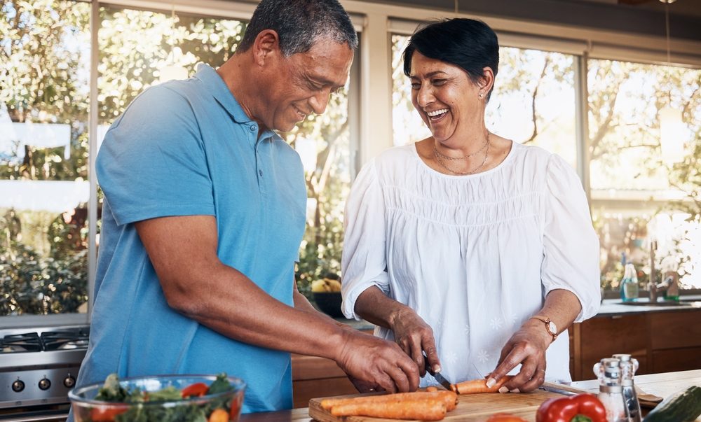Senior Couple preparing food in kitchen