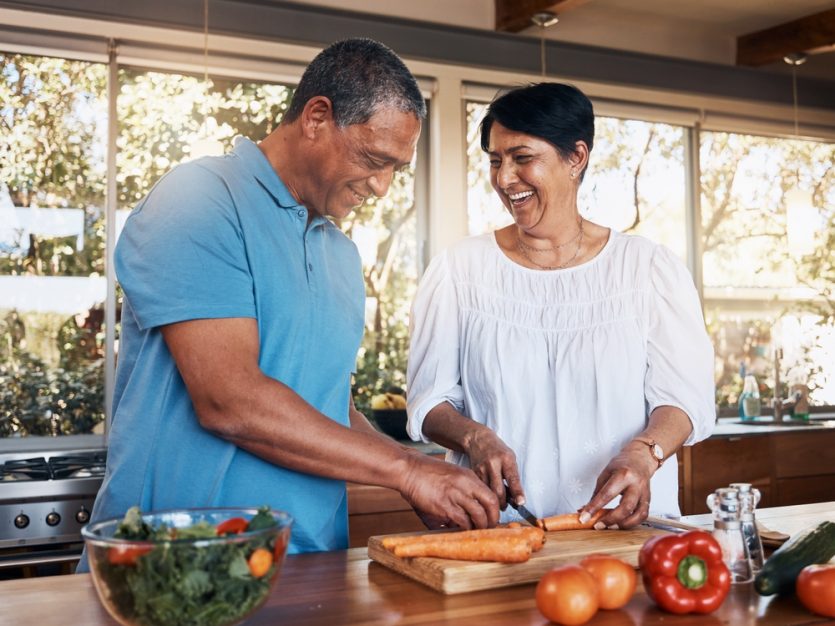 Senior Couple preparing food in kitchen