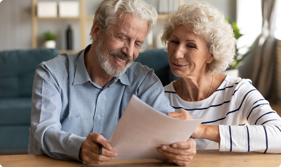 Elderly couple reviewing documents together