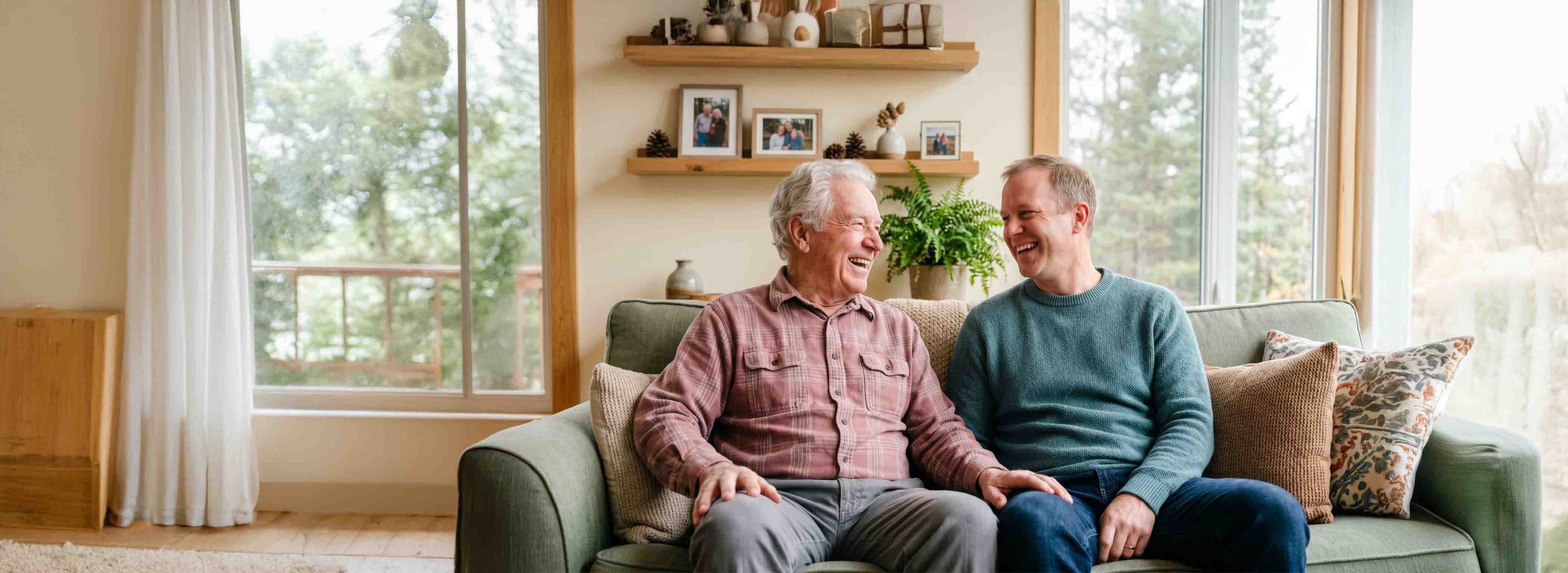 Elderly man and son sat on a couch