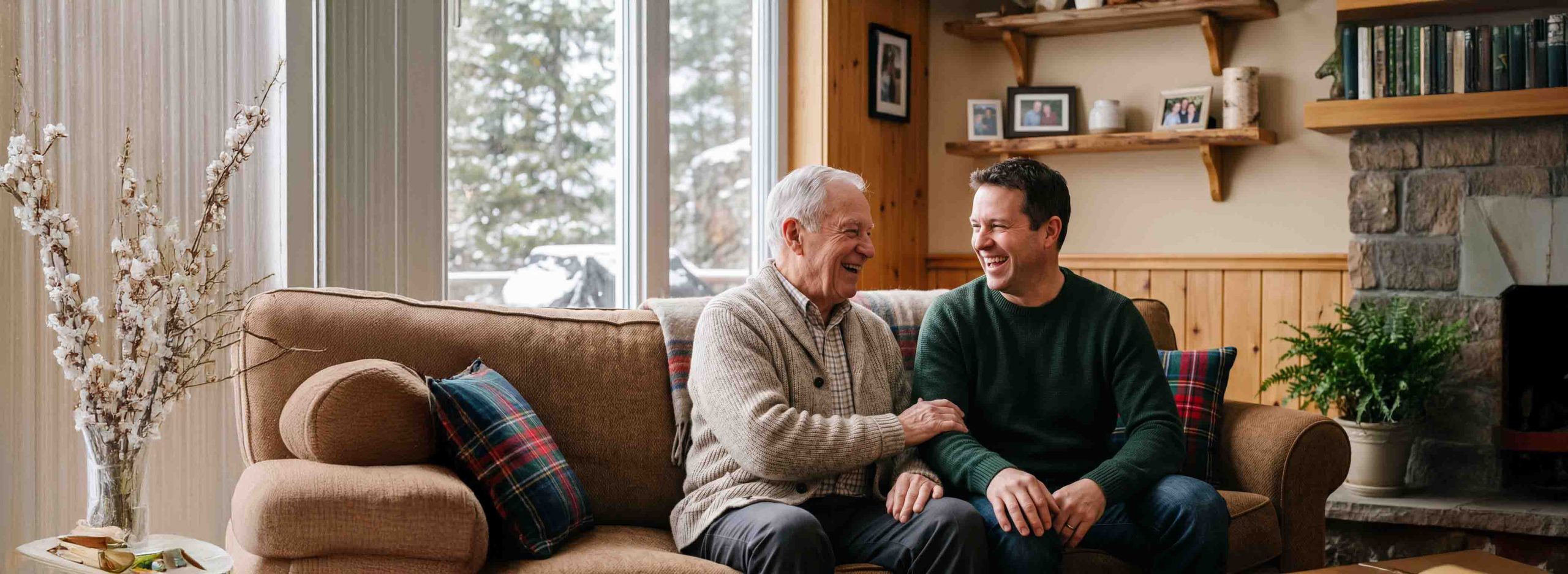 Elderly man and son sat on a couch