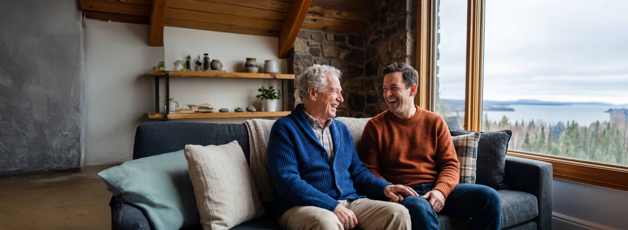 Elderly man and son sat on a couch
