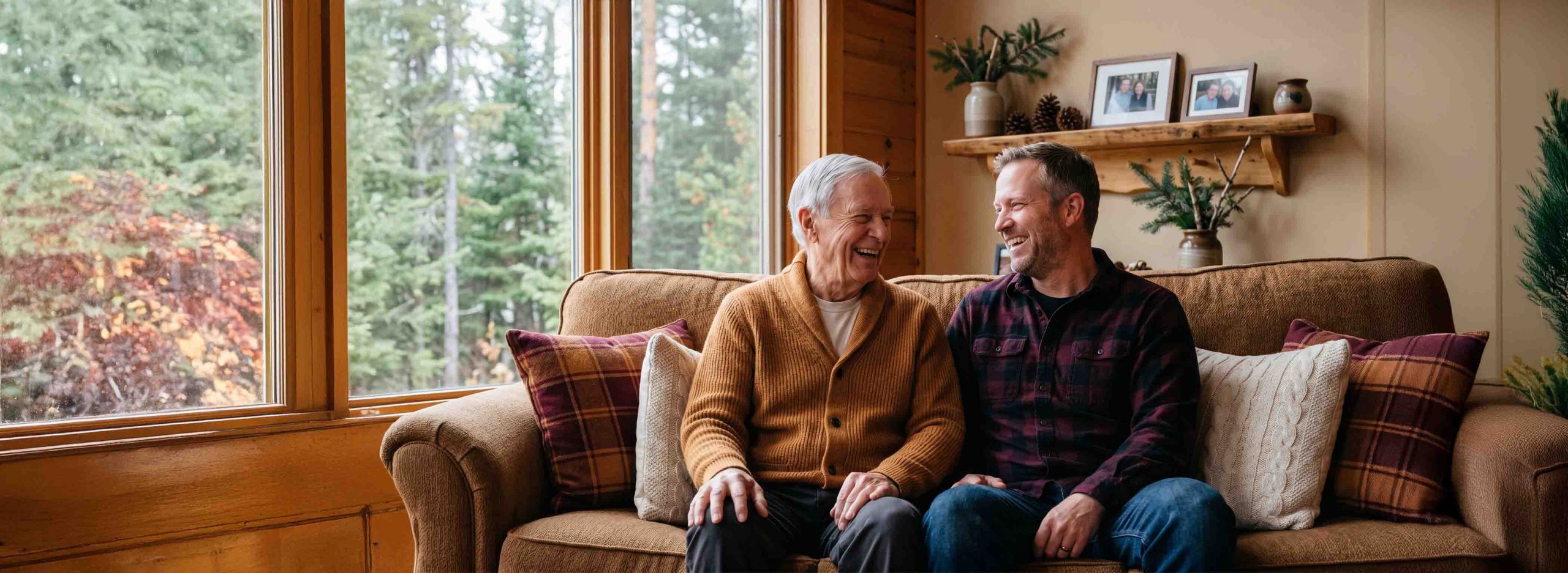 Elderly man and son sat on a couch