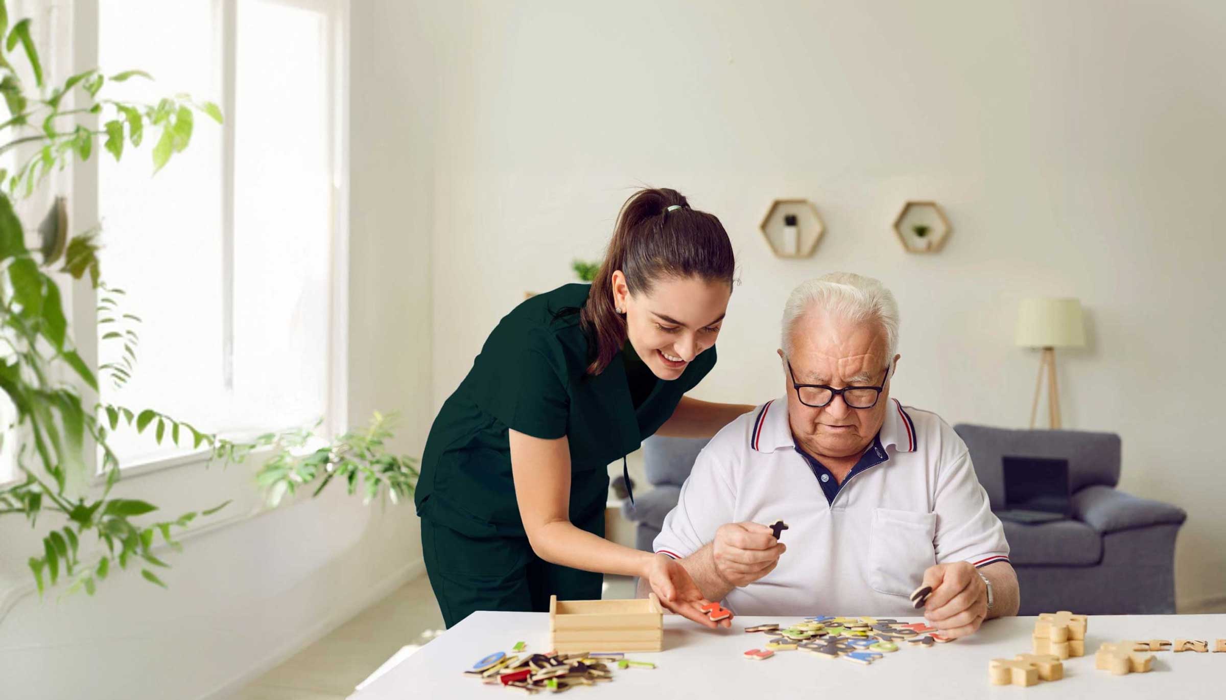 Elderly woman and daughter smiling while sat on a couch