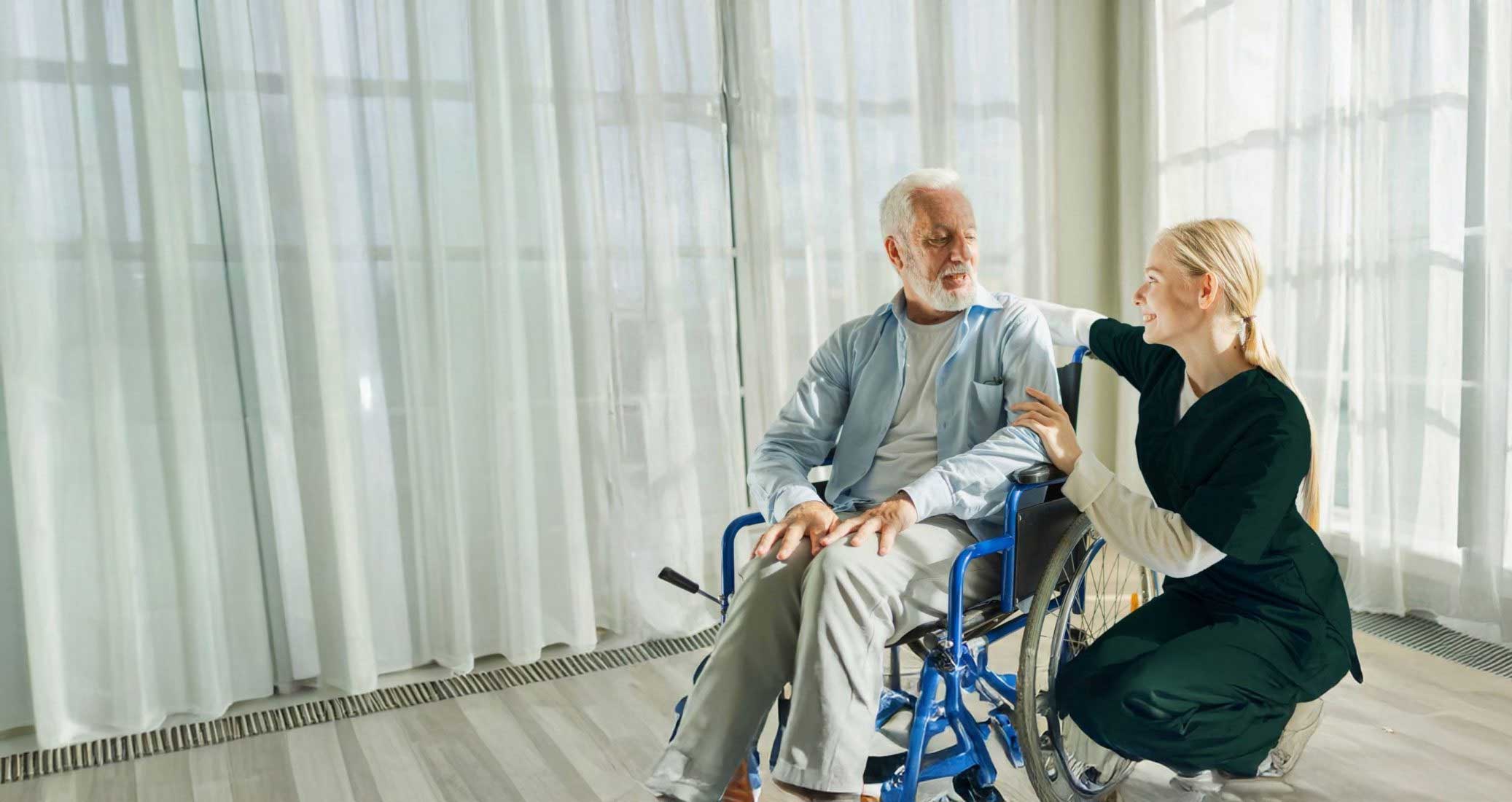 Caregiver assisting senior in wheelchair