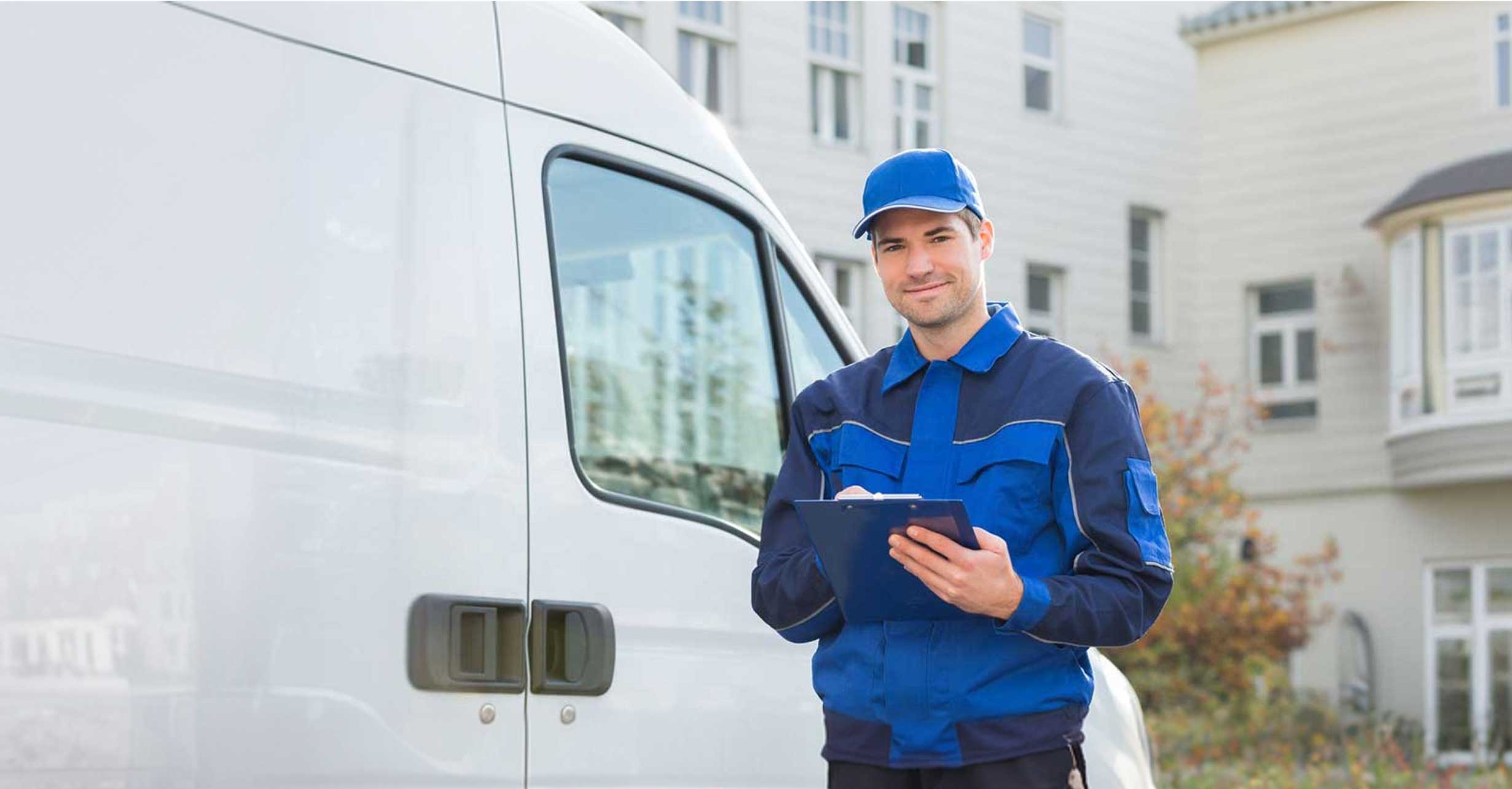 Delivery person with clipboard by van