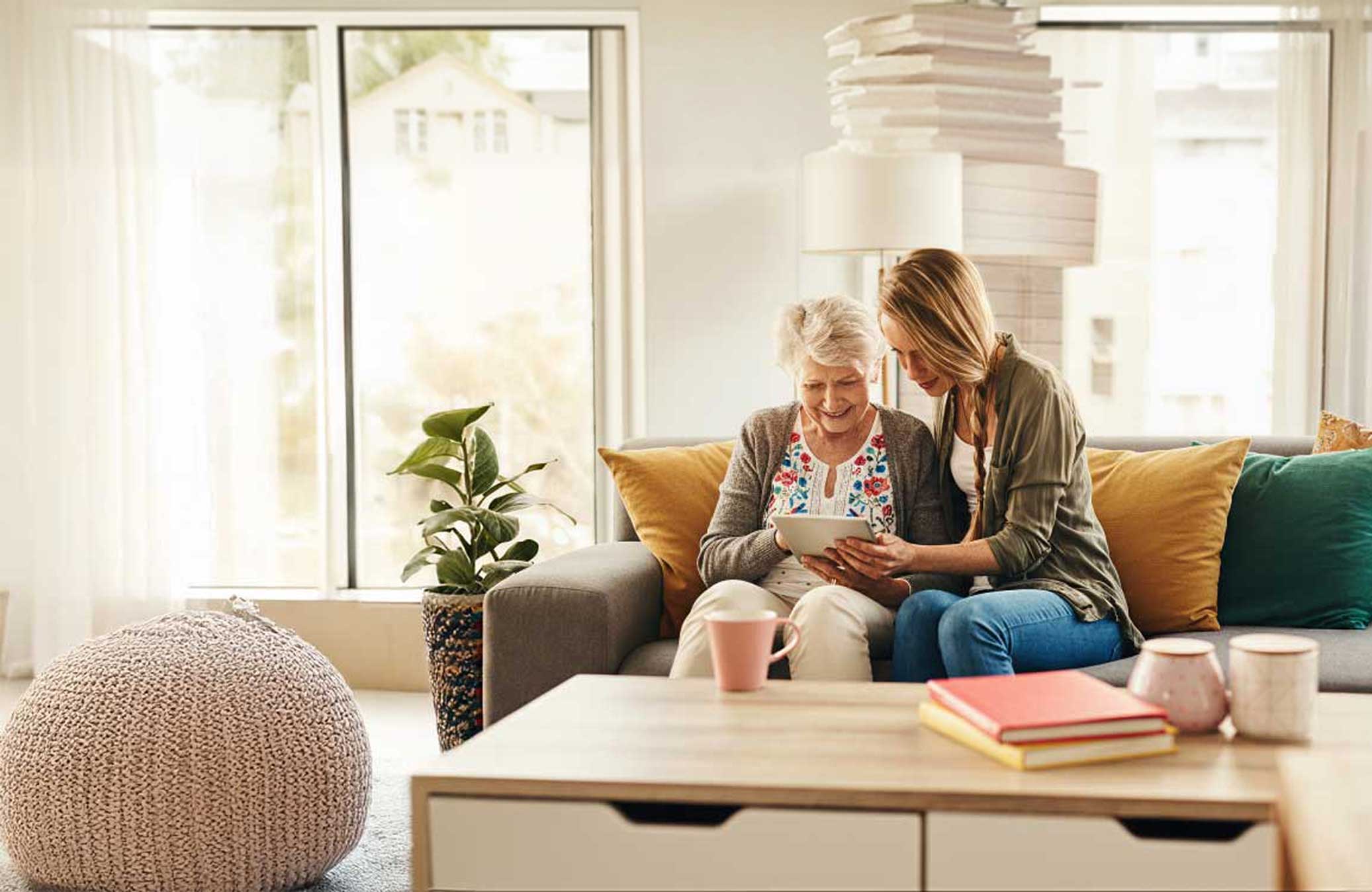Two women sharing a tablet together