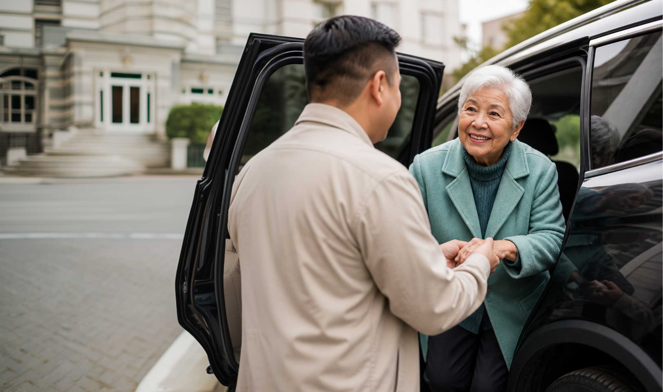 Man assisting elderly woman into car