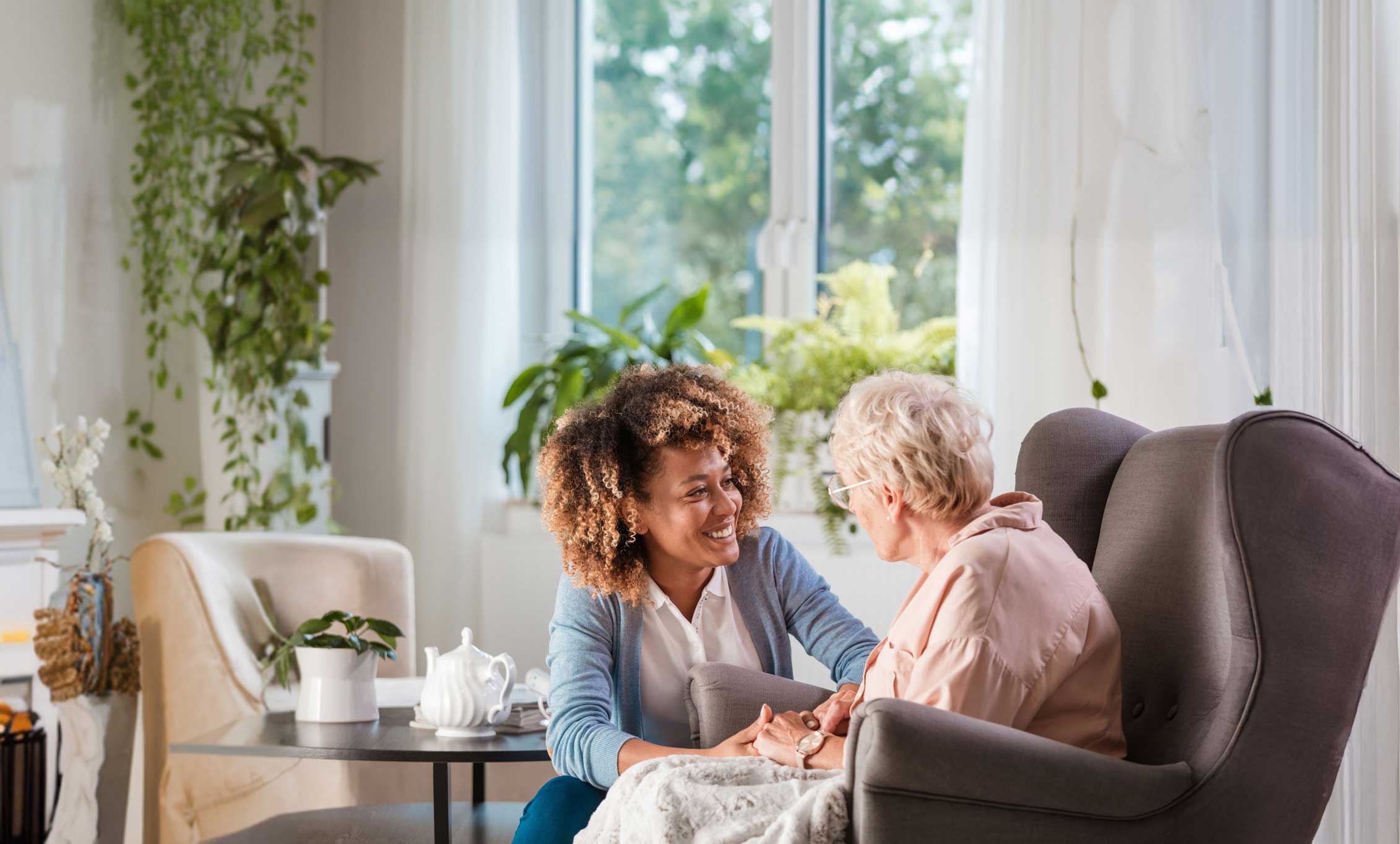 Caregiver interacting with elderly woman