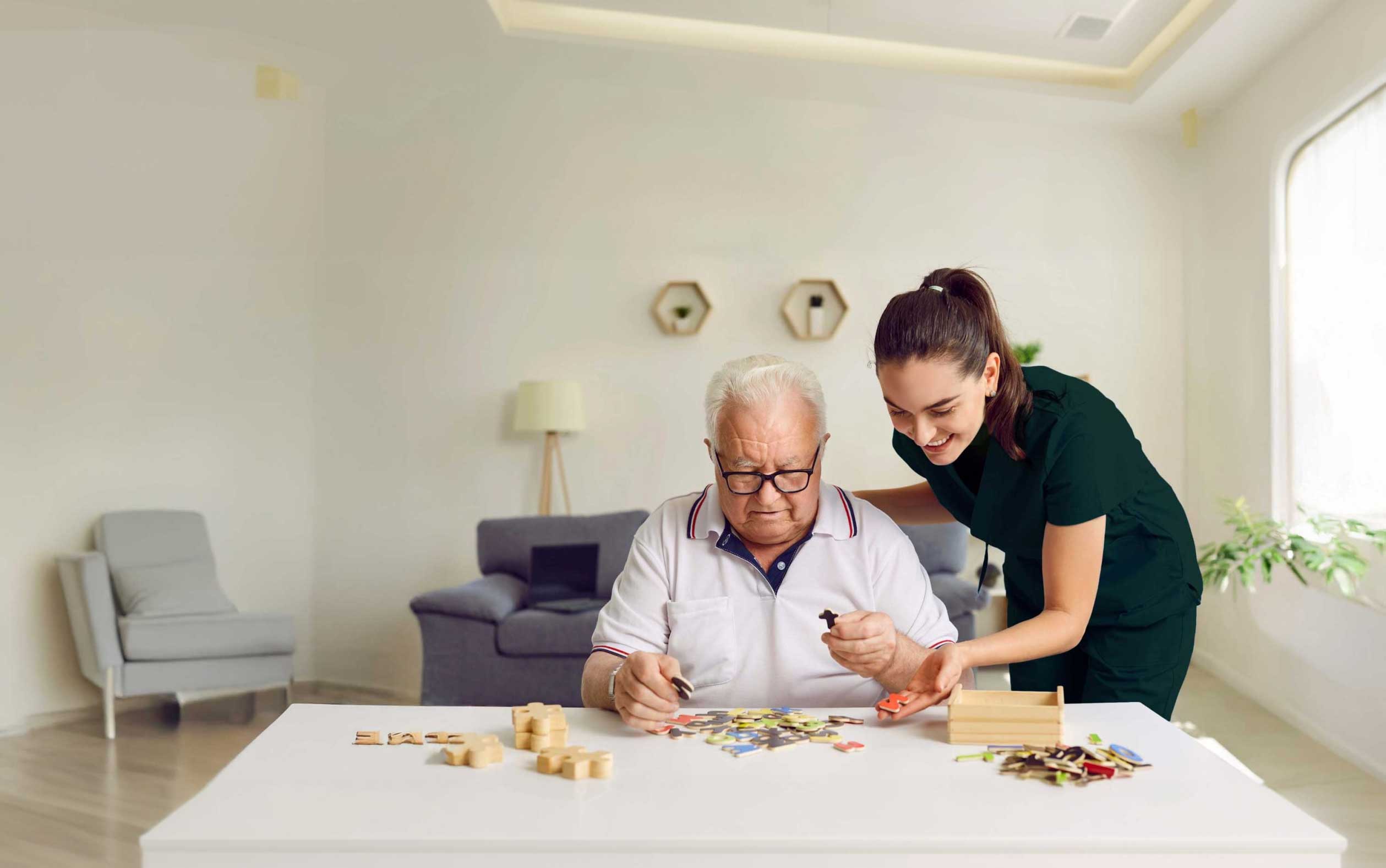 Caregiver assisting senior with puzzle.