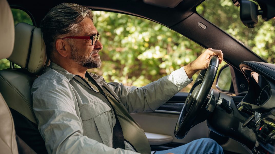 3 ways to support safer driving as we age 1 Side view of senior man that is driving a car.