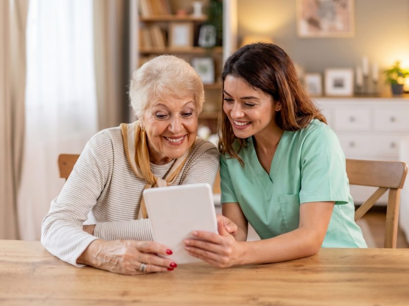 Elderly woman with a caregiver