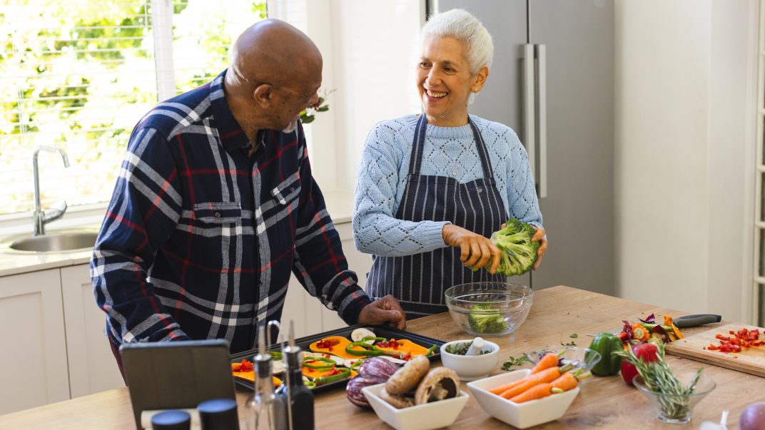 The Mediterranean diet keeps making headlines. What does the evidence actually say? 1 senior couple preparing healthy meal with vegetables in kitchen