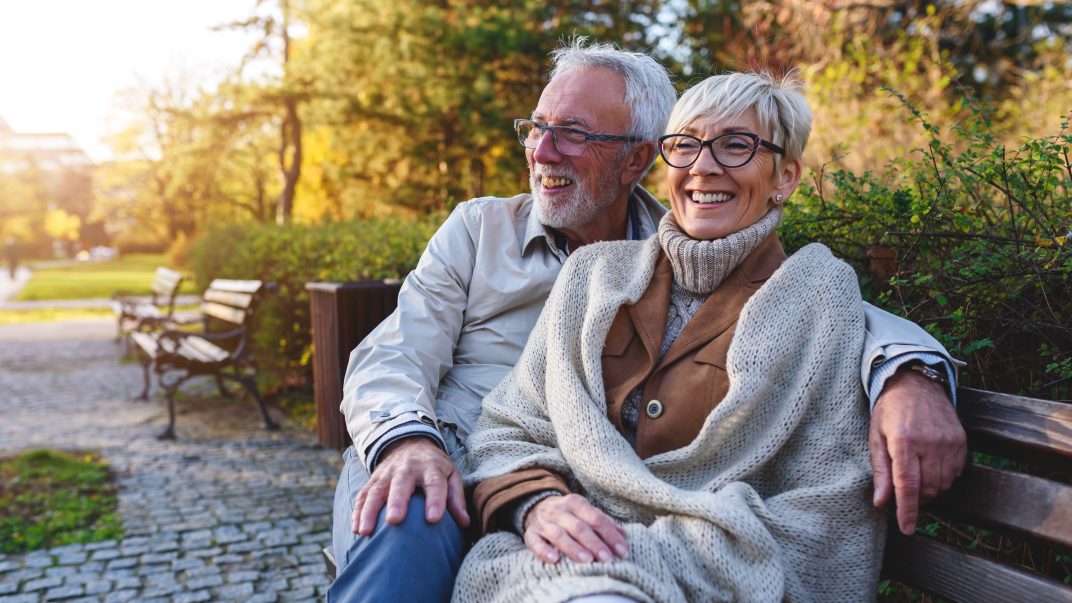 Happy elderly couple enjoying outdoors - Fall Home Prep
