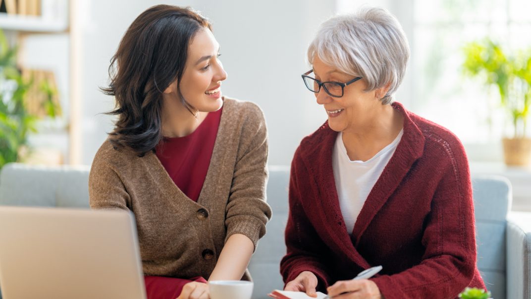 Mental health doesn't retire 1 Two women smiling and conversing together.